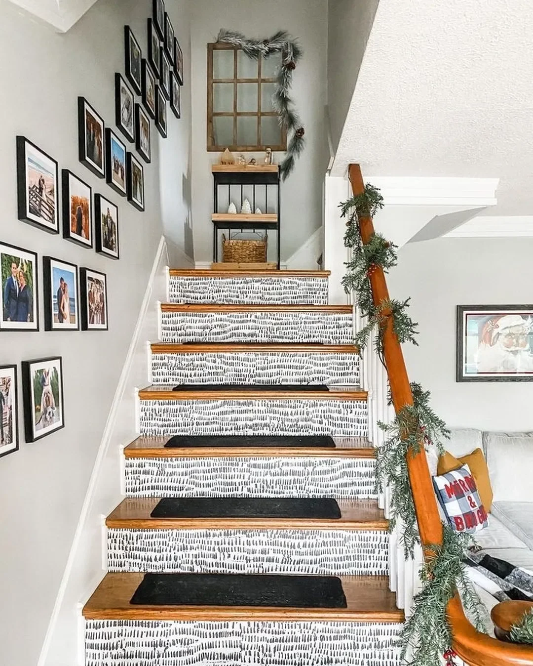 A staircase gallery designed with a few frames and holiday accessories to fill the mood.