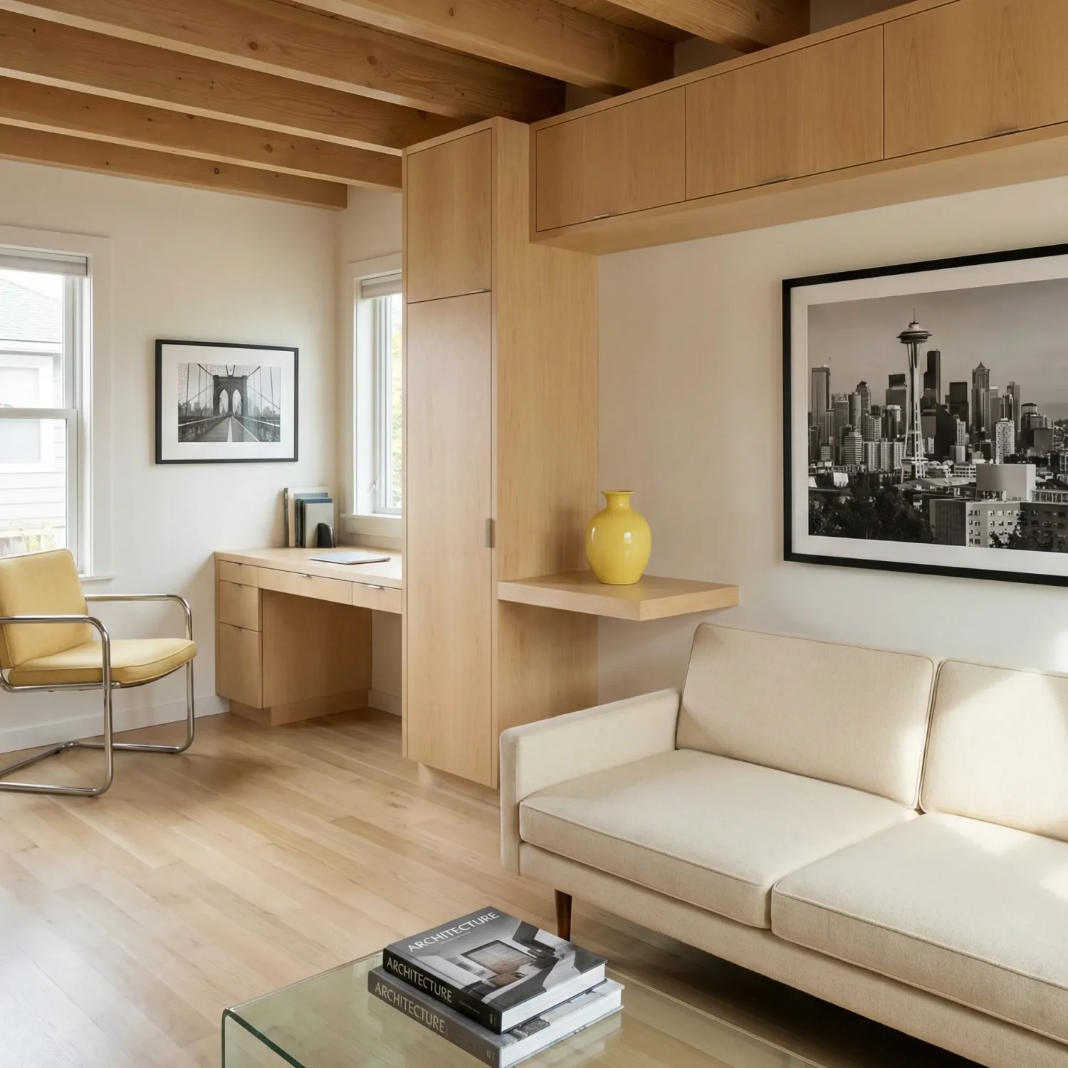 Minimal living space with sofa, desk, and city wall art