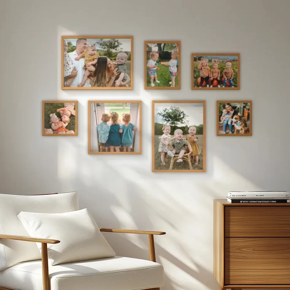 Gallery wall of cheerful family photos in warm wood frames