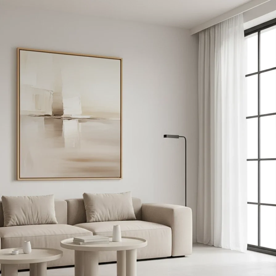 large abstract canvas hangs above beige sofa in minimal room