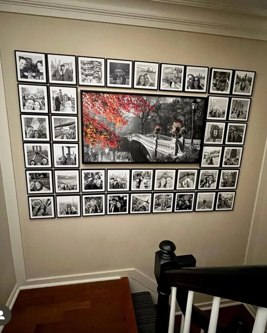 A staircase landing featuring one large statement photo surrounded by other smaller photos.