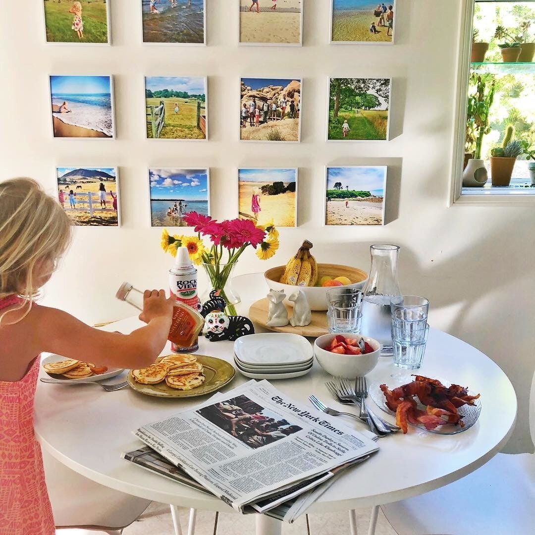 Updating their Mixtiles collection with new photos, adding fresh memories to their personalized wall art.