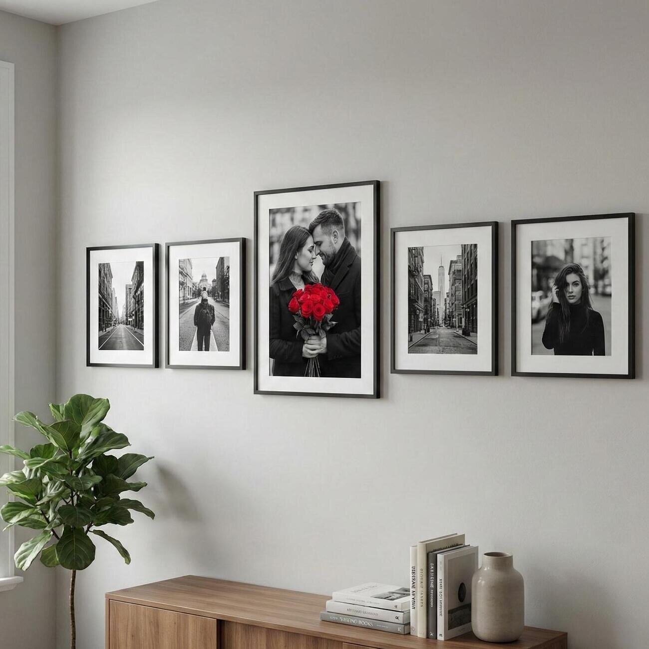Black-and-white photo gallery with central couple holding red roses