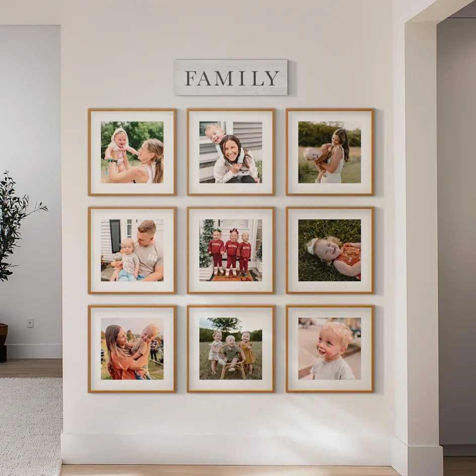 Floor-to-ceiling framed photo grid on wall