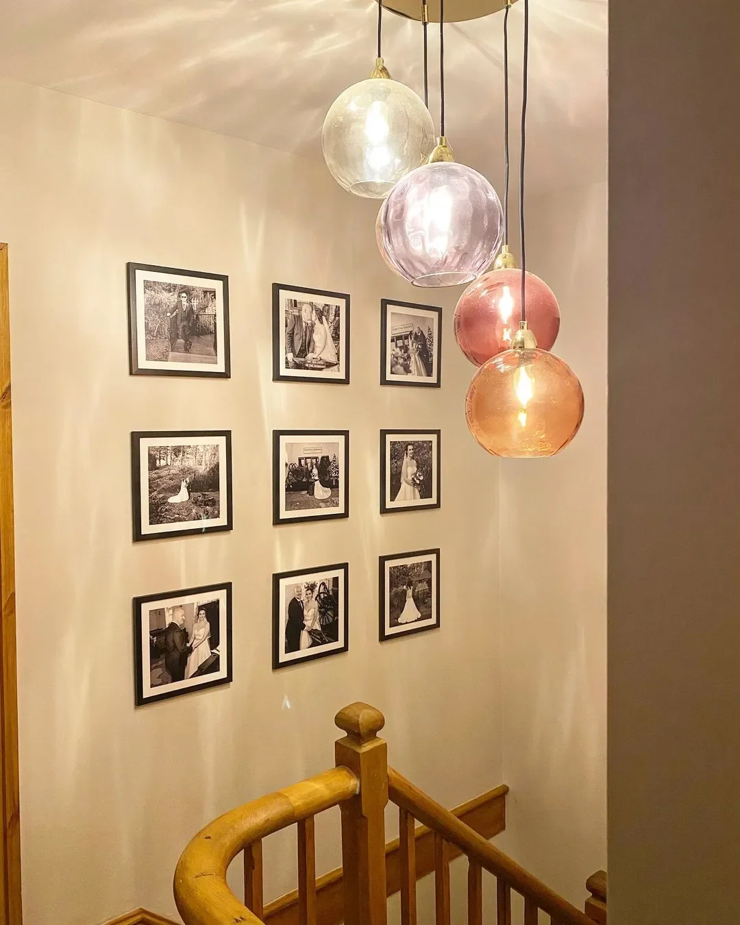 A staircase wall starting with wedding photos at the base and continuing upward with life-chapter images.