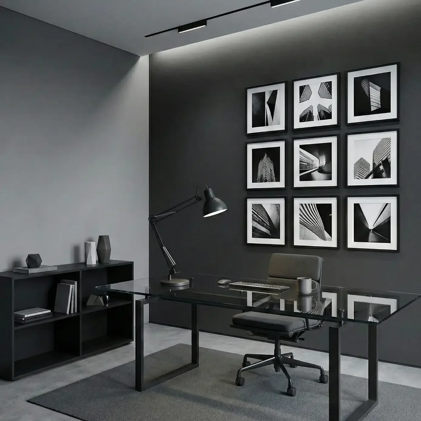 Minimalist black office with glass desk and photo gallery