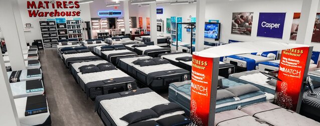 Mattress Warehouse showroom image featuring several mattresses