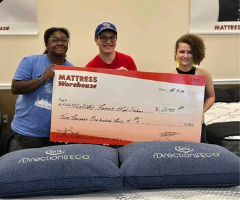 kids with fundraising check