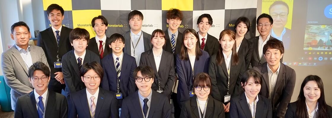 A diverse group of four business professionals in a modern office discussing strategy around a table, with laptops and documents visible, symbolizing collaboration between finance and engineering teams.