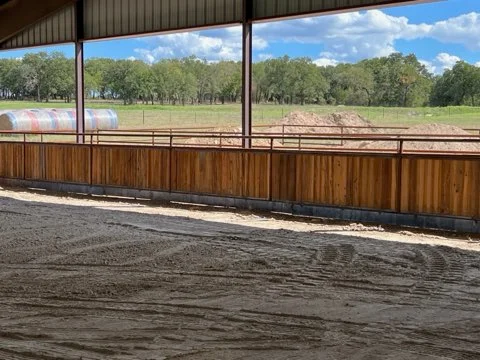 Covered riding arena with freshly prepared footing