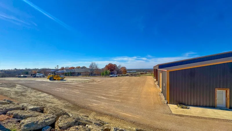 Prepared pad and gravel work beside a metal shop