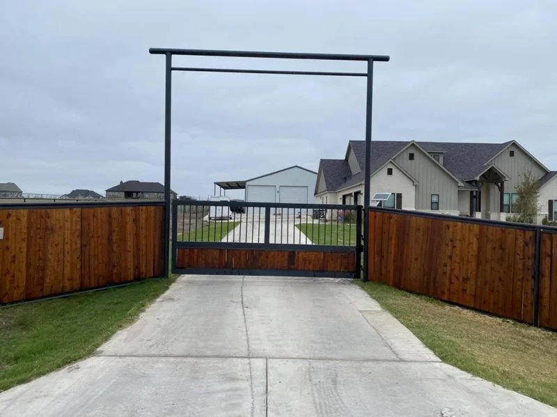 Custom ranch gate with wood panels and metal framing