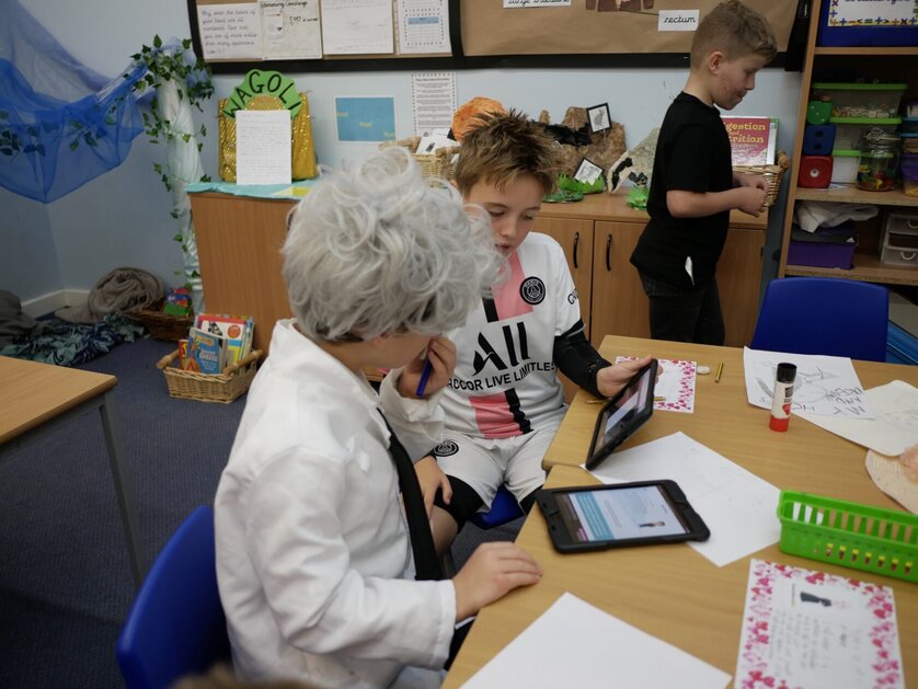 Boy with tablet dressed as Albert Einstein