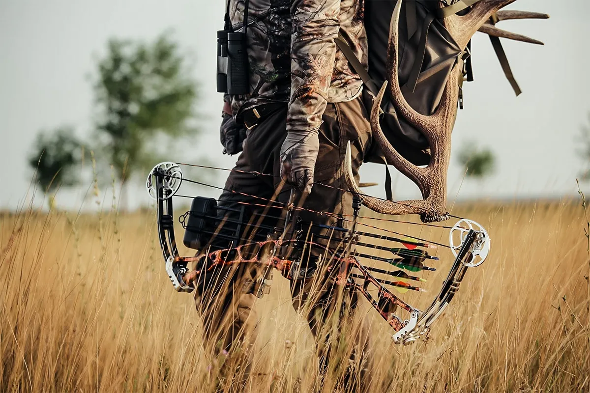 walking through field with bow