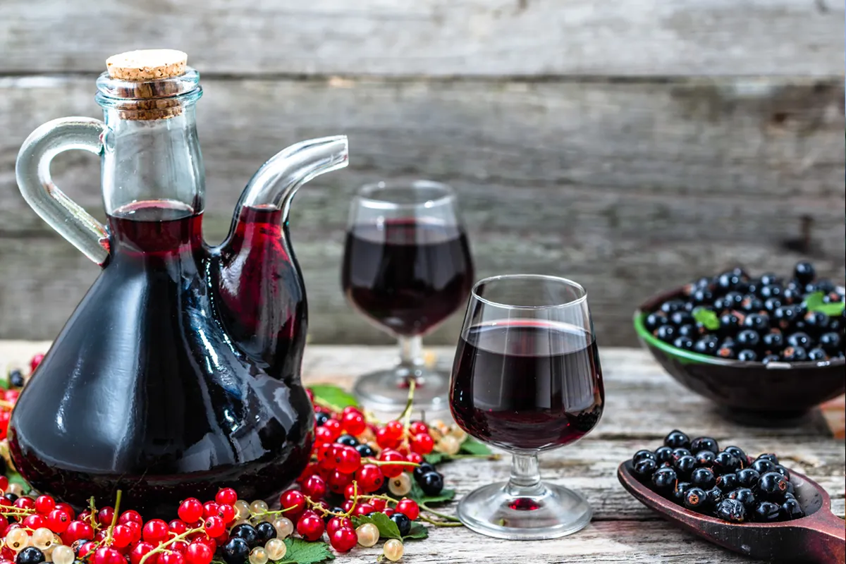 homemade wine in decanter on table with grapes and glasses