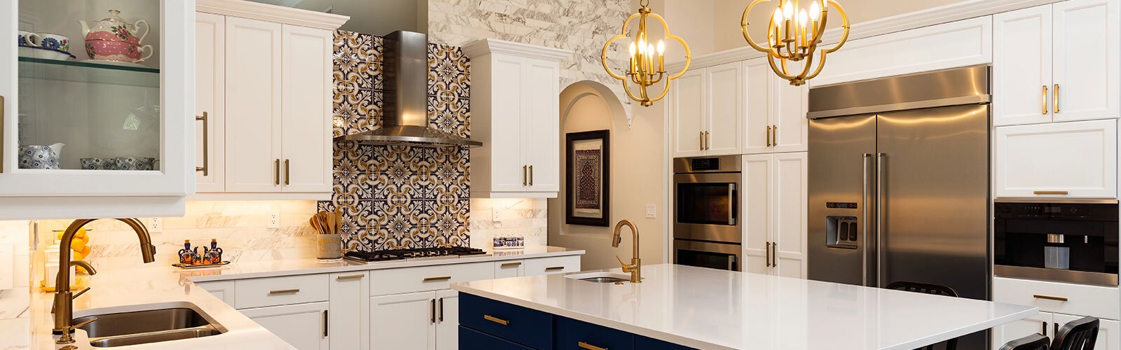 A beautiful kitchen with two sinks and ample lighting.