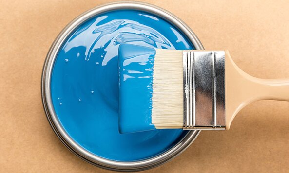 A brush dipped in blue paint.