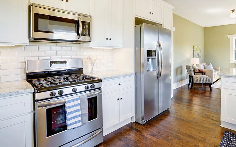 Freshly updated white and green kitchen room interior.
