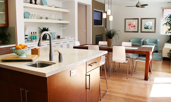 A clean, naturally lit home featuring the kitchen and dining room.
