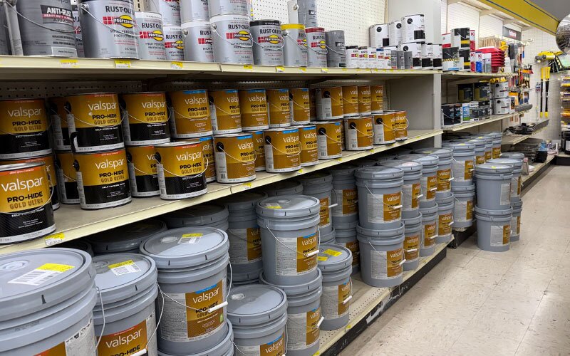An aisle of interior and exterior paint at Johnson Wholesale Lumber.