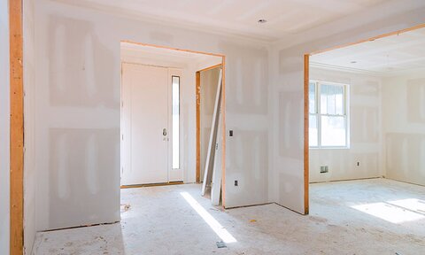 Interior construction of the foyer of the home with natural light.