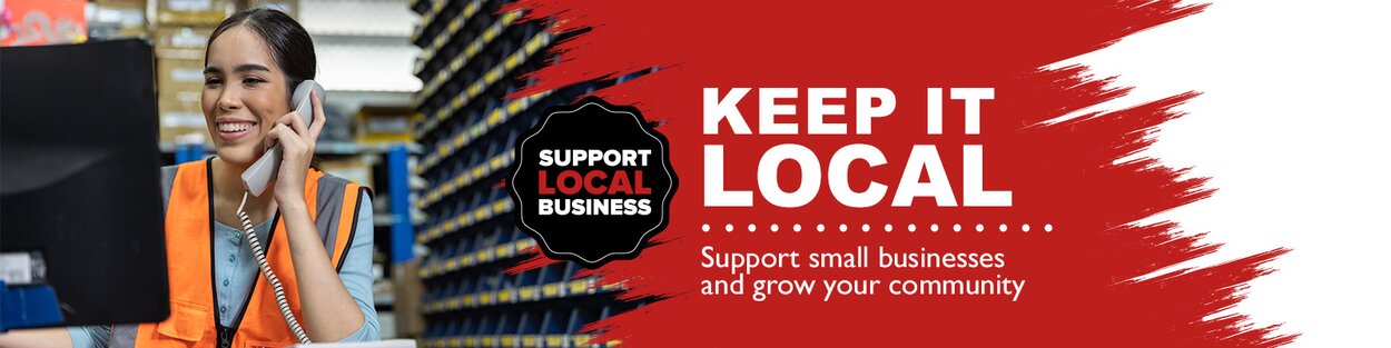 A happy hardware store employee on the phone with a customer.