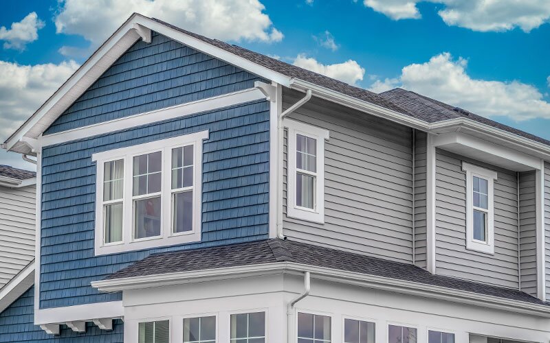 Classic single-family home facade with blue and grey siding.