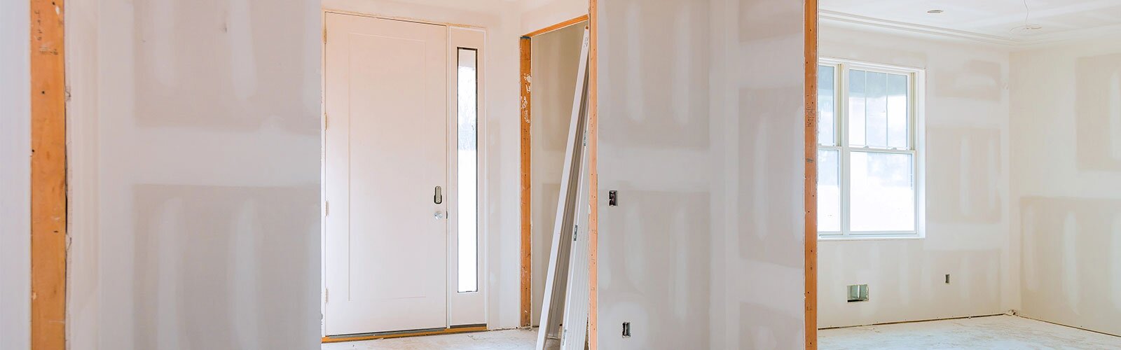 Interior construction of the foyer of the home with natural light.