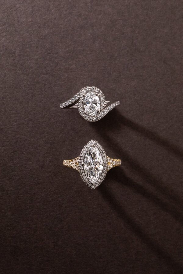 Halo diamond engagement rings featuring oval and marquise cut centre diamonds.