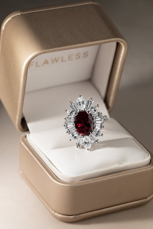 Unique bespoke ruby ring surrounded by sparkling diamonds
