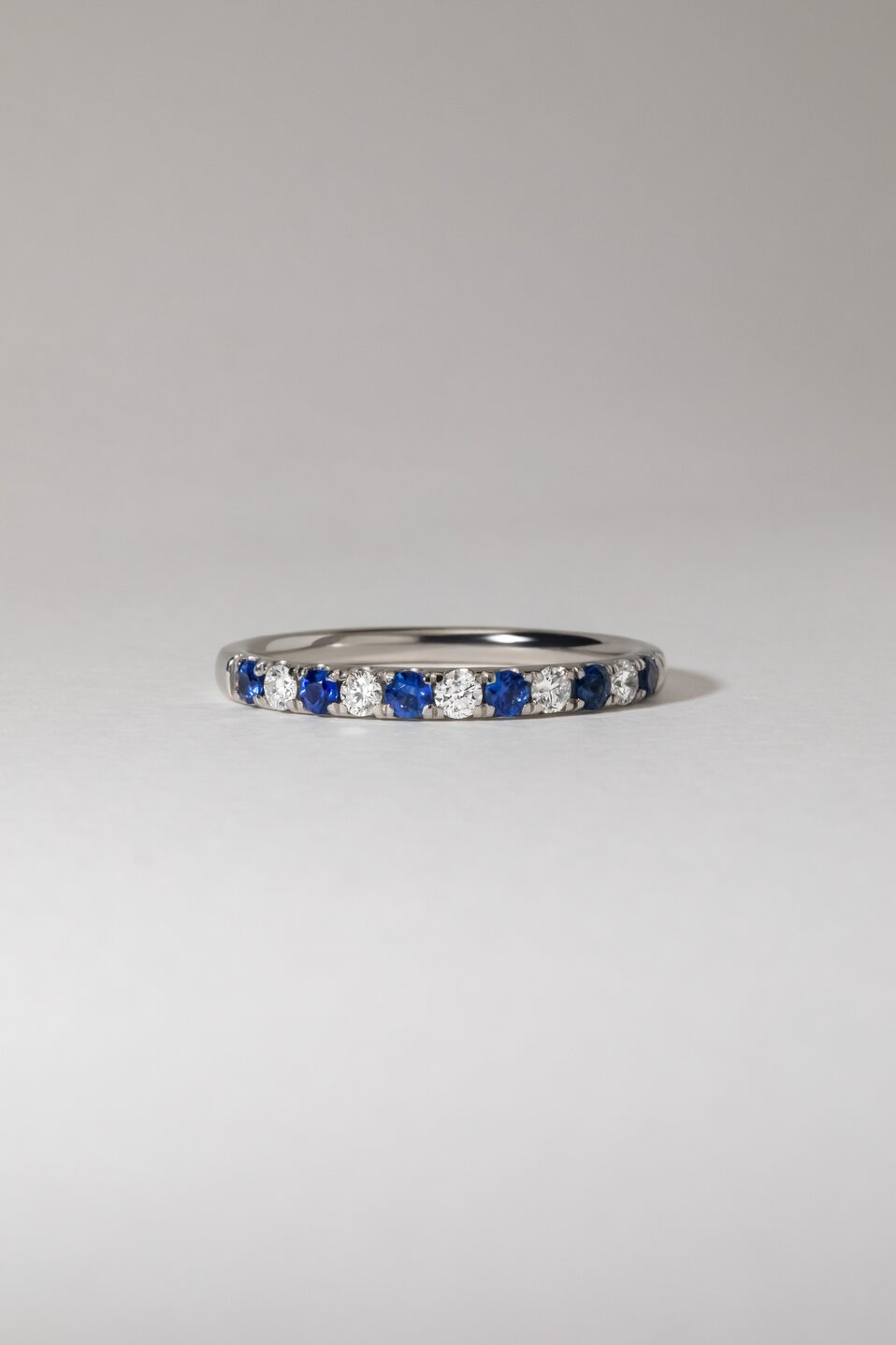 0.25 Carat Natural Round Blue Sapphire And Diamond Micro Set Half Eternity Ring in Platinum