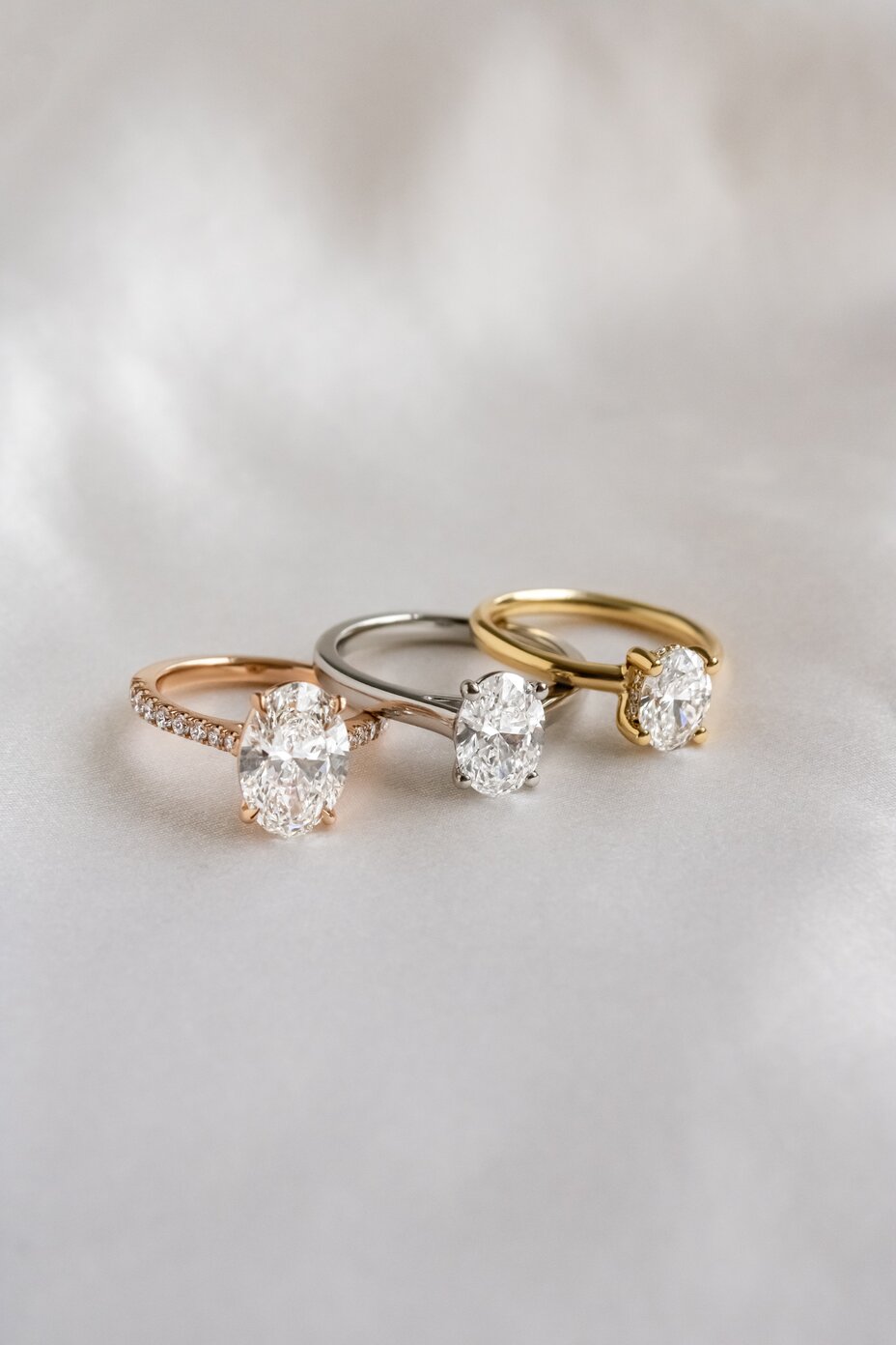 Oval diamond engagement rings showcasing classic solitaire settings in mixed metals.