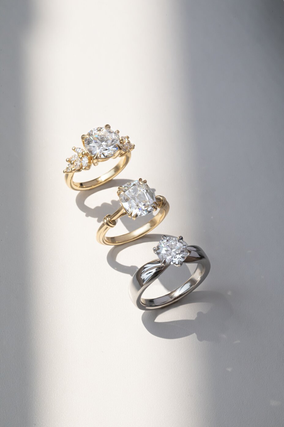 Collection of diamond rings in yellow and white gold featuring mixed diamond cuts