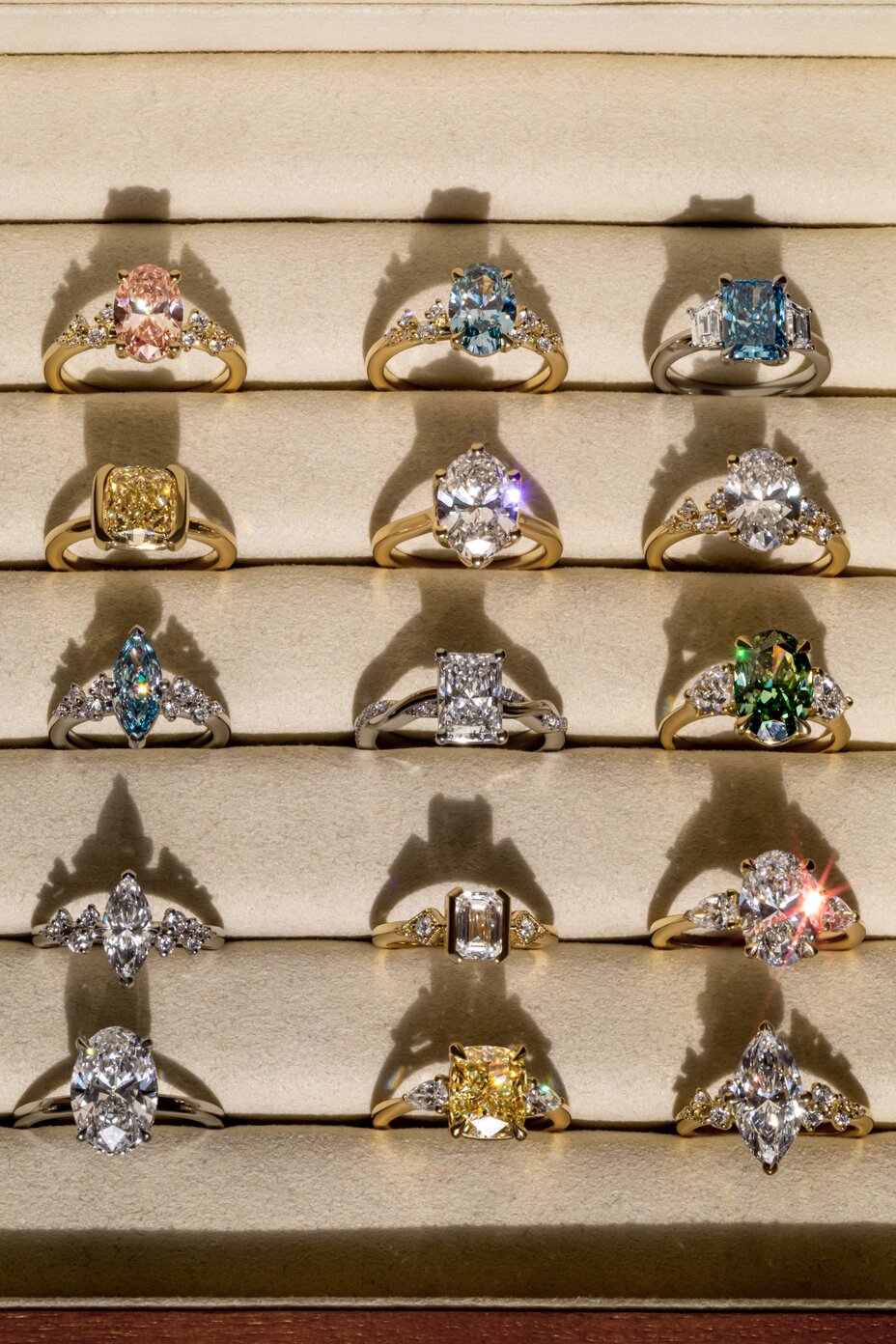 A curated collection of lab-grown engagement rings featuring multicoloured diamonds in various cuts and metal settings