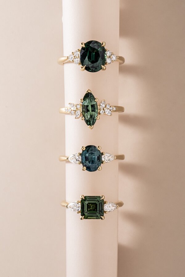 Green sapphire engagement rings featuring oval, marquise and emerald cut centre stones.