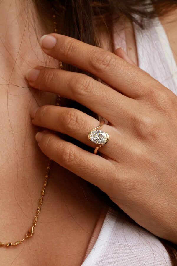 oval diamond wave split band engagement ring in yellow gold bespoke Naia