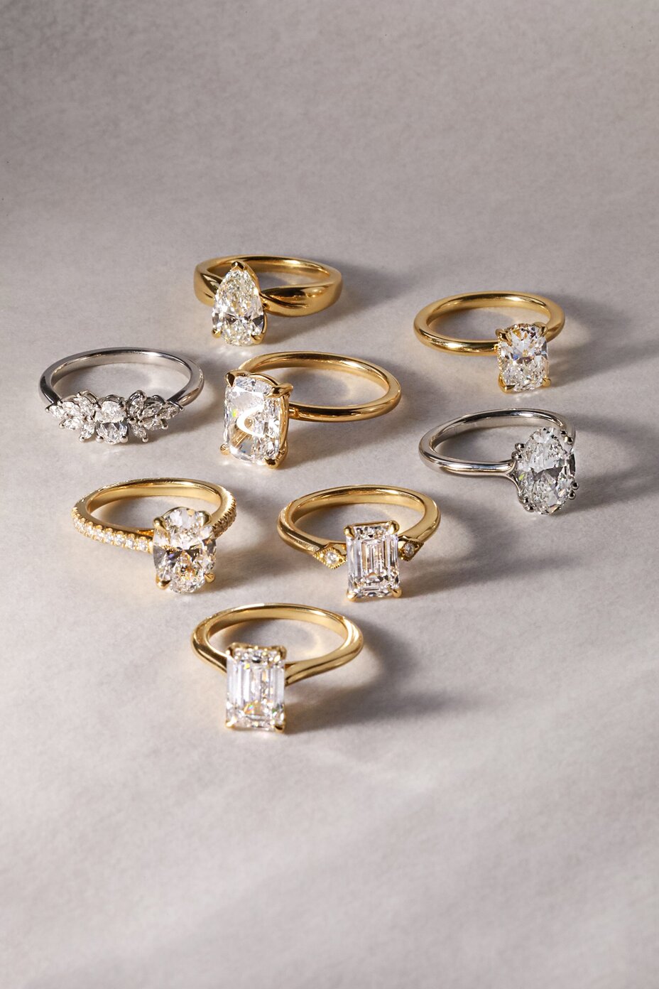 Diamond engagement ring collection featuring oval, emerald, pear and cushion cut designs in mixed metals.