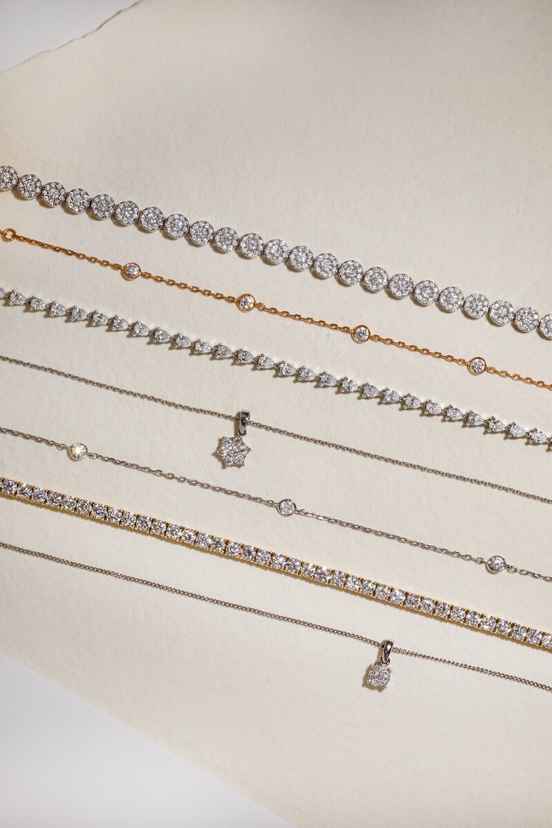 Yellow gold and white gold diamond bracelets with various settings and elegant bracelet styles