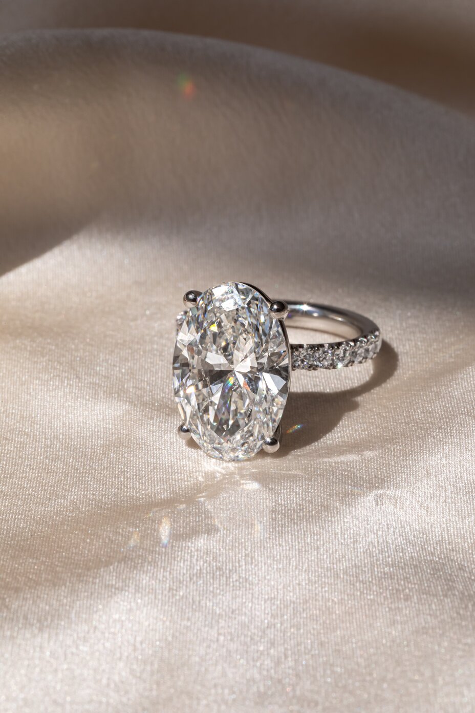 Samara platinum hidden halo diamond ring with oval cut center stone
