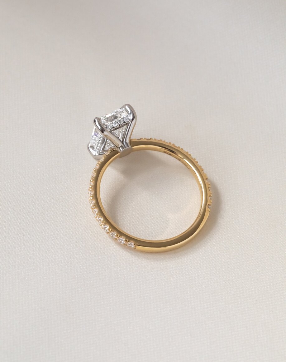 Two tone hidden halo radiant engagement ring with golden diamond band and platinum diamond setting Sadie