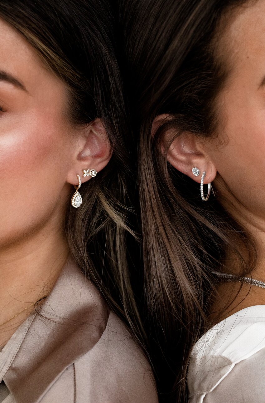 Models wearing diamond earrings in white gold