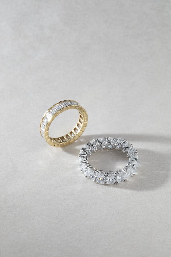 Oval and emerald cut lab grown diamond full eternity rings in platinum and yellow gold.