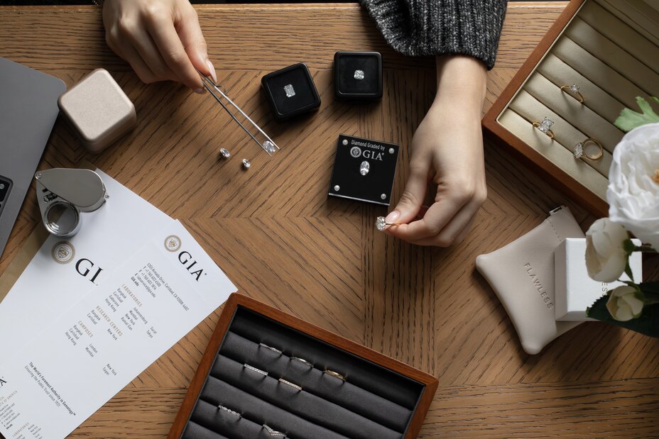 consultation with a jeweller showing multiple loose diamonds, discussing certificates and diamond ring style choices