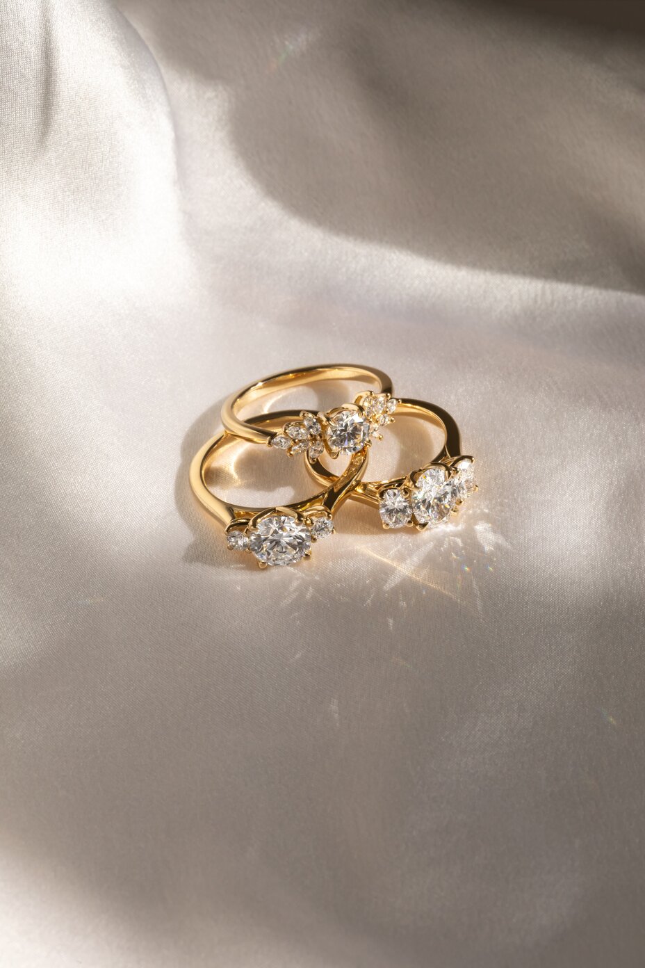 Yellow gold round-cut diamond ring featuring a cluster design with a Trilogy setting