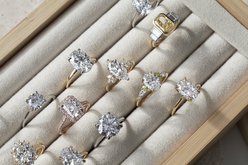 Diamond engagement rings in a ring display box featuring multiple styles, metals and diamond shapes