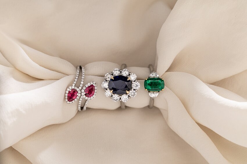 Colourful gemstone rings featuring ruby, sapphire, and emerald in elegant precious metal settings.
