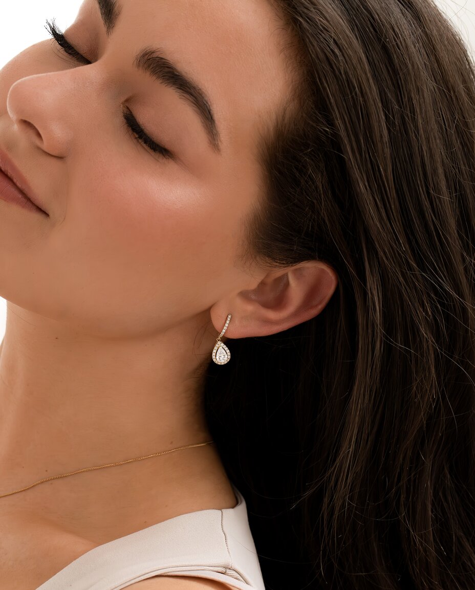 model wearing white gold, drop, halo style, pear diamond earrings