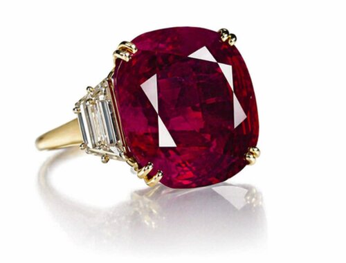 oval Burmese ruby trilogy engagement ring in yellow gold