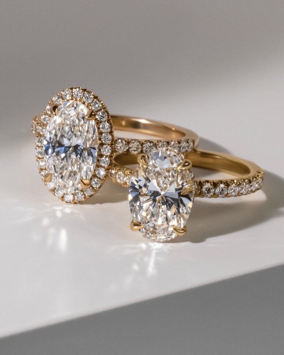 Oval diamond rings in yellow gold with halo and solitaire designs