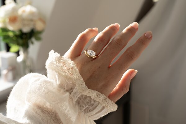 Oval diamond east west engagement ring in yellow gold flow